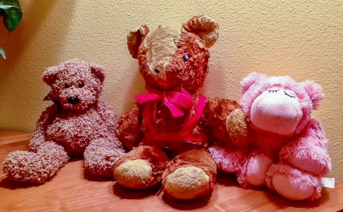Teddy bears from 1934 middle bear to 1995 bear on the left to 2016 the pink bear on the right with lavender in it. The whole bear may be microwaved.